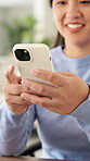 Woman, online and hands with phone in home, scroll or communication with contact on social media app. Typing, message and happy person with mobile for funny chat, browsing and networking on website