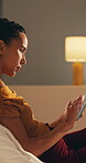 Night, phone and relax with woman on sofa in home living room for social media browsing or scrolling. App, evening and reading with person in apartment for email search or typing text message