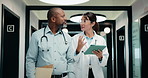 Tablet, walking and doctors at clinic for planning, schedule discussion or healthcare history. Hospital, people and medical team with tech for report, advice and greeting with nurse in hallway