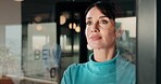 Smile, thinking and business woman in window for idea, inspiration or planning for property. Glass, reflection and commercial realtor with vision for future, happy and looking at real estate