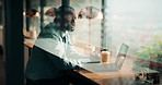Laptop, man and thinking in coffee shop with stress, worried or decision for online business. Entrepreneur, typing and person in cafe for startup risk, confused or loan application in window