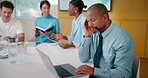 Headache, meeting and man in office with laptop, tiredness or pain with task management. Fatigue, tension and mature person in boardroom with migraine, strain or deadline pressure with sore head.