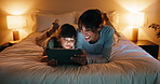 Bed, tablet and mom with child for reading, story time or bonding in home at night. Woman, family or happy mother with daughter on digital app for playful connection, ebook or streaming service