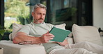 Tablet, relax and smile with man on sofa in home for social media post, chat forum and ebook app. Digital library search, blog article and happy with mature person in living room of apartment