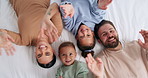 Parents, children and face with wave on bed, above and happy with bonding, laying and relax in home. People, kids and smile for portrait with hello, connection or rest on weekend at family house