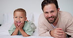 Face, father and child on bed with smile, bonding together and family connection on weekend break. Happy, dad and young son in home with wellness, parent care and support for childhood development.