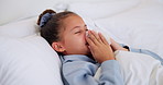 Sick, girl and blowing nose with tissue in bed for fever, influenza or viral infection in home. Child, kid and cough with cold, flu or sinus in bedroom sheets for hayfever, allergy or virus in house
