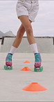 Cone, legs or person with roller skating for practice, agility exercise or precision training activity. Skate park, fitness and woman with challenge for coordination, feet and movement development