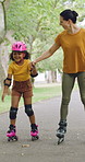 Rollerskate, happy and mom with girl in park for bonding with activity, hobby and learning on weekend. Family, holding hands and woman with child for skating, exercise and practice together outdoor