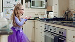 Child, fun and cool dance in home kitchen with energy, childhood and tutu dress with wellness. Girl kid, goofy dancer and freedom with development, play and growth with movement in family house