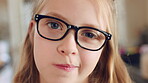 Face, girl and glasses with child in home on weekend for curious expression, growth or intelligence. Development, thinking and youth with cute kid in apartment for holiday, question or vision