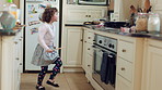 Dance, smile and kid with spoon in kitchen for weekend fun, childhood and motor skill development. Rhythm, utensil and girl with playful expression of happiness in home, jump and movement for music