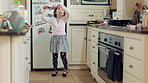 Dance, development and energy with girl in kitchen of home for expression, movement or rhythm. Ballet, music and wooden spoon with dancer child in apartment for growth, morning fun or practice
