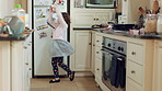 Dancing, smile and child with spoon in home for weekend fun, coordination and motor skill development. Childhood, utensil and girl with playful expression of happiness, music and movement in kitchen