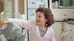 Eating, energy and child with wand for playing, creative imagination or spin for spell in home. Snack, happy kid or playful with magic toy in kitchen for pretend wizard, development or healthy growth