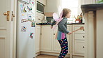 Costume, dance or girl with smile in kitchen, creative expression or childhood for imagination growth. Playing, spoon and happy child with fantasy dress up for development, home and moving to music
