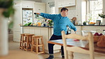 Happy, dance and man with down syndrome, energy and listening to music on weekend break in kitchen. Male person, spin and movement in home with dancer performance, feel good vibe and song for rhythm.