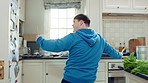 Kitchen, dance and teen with spoon, happy and performance for cooking success and moving with energy. Dancer, active and person with down syndrome, rhythm and celebration for culinary skills in house