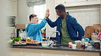 Dancing, cooking and friends with high five in kitchen for bonding, support or listening to music. Happy, groove and male people with rhythm to radio on weekend with preparing meal together in home.
