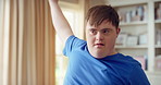 Man, dancing and active in lounge, rhythm and moving with energy and celebration on university break. Happy, home and person with down syndrome, excited and student with smile on weekend or fun