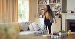 Singing, dance and woman with remote in home for good mood, positive energy and karaoke. Happy, living room and person with lyrics for music, audio and playlist for groove, dancing and fun on weekend