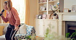 Singing, dancing and child with remote in home for fun, expression and relax on weekend with music. Happy, living room and girl with headphones for streaming radio, audio and playlist for karaoke
