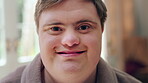 Happy, face and man on break in house, relax or confident with robe on peaceful holiday and wellness. Portrait, smile and person with down syndrome, pride and positive attitude on weekend in home