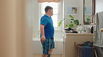 Man, dancing and rhythm with mirror in bathroom for entertainment, morning routine and grooming. Smile, dancer and moving with energy, musical performance and male person with down syndrome in home