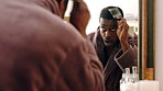 Mirror, dance and black man in bathroom with comb, morning routine or grooming to start day with wink. Home, reflection and person with energy, haircare and maintenance for beauty with self care