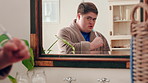 Mirror, sing and man with toothbrush for oral hygiene, wellness and grooming with rhythm in bathroom. Dance, reflection and person with down syndrome, celebration and dental care with tool in house