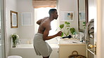 Dancing, bathroom and happy man with towel for hygiene, fun vibe or morning routine in home. Excited, male person or energy with movement in mirror for fresh wash, cleaning or grooming in house