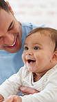 Smile, playing and baby with parents in home for bonding, connection and early childhood development. Happy, cute and child with mother and father for family together with growth on weekend in house.