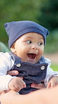 Happy, baby and playing with parents in nature for early childhood development or outdoor bonding. Child, kid or playful toddler laughing with guardians for fun weekend or holiday in park together