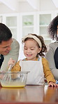 Support, teaching and kid baking with parents in kitchen for recipe preparation in family home. Mixing, cooking education or girl learning for child development with mom, dad and dessert or treat