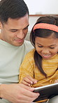 Tablet, kid and father on sofa in home for bonding, teaching and online learning with help. Family, support and man or dad with daughter on digital app, interaction and connection for development