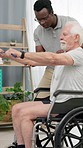 Physiotherapy, resistance band and senior man in wheelchair for mobility, wellness or healing. Healthcare, physical therapist and person with disability stretching for shoulder pain, recovery or help