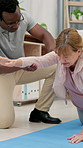Consultation, arm and physiotherapist with senior woman in office for exercise, rehabilitation or recovery. Checkup, professional and medical worker with elderly female patient for physical therapy.