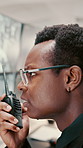 Monitor, security or black man with radio in control room, cctv observation or dispatch instructions. Vigilance broadcast, talking or guard with tech for crime prevention, relay info and safety check