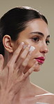 Woman, face and cream for skincare with beauty, moisturiser or product isolated on studio background. Natural cosmetics, female person and lotion for aesthetic, skin glow or dermatology for hydration
