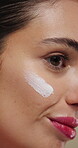 Woman, face and lotion for skincare with beauty, moisturiser or product isolated on studio background. Natural cosmetics, female person and cream for aesthetic, skin glow or dermatology for hydration