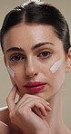 Woman, face and moisturizer for dermatology with beauty, lotion or product isolated on studio background. Cosmetics, person and portrait with cream for aesthetic, skin glow or skincare for hydration