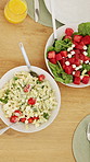 Above, food and lunch on dining table with drinks, healthy nutrition and cutlery for gathering in home. Plate, utensils and meal in house with chicken, vegetables and orange juice for hosting feast.