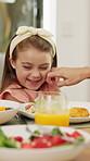 Lunch, parent and playful with child at table for teasing, healthy meal or pinch cheeks for bonding. Food, family or playing with girl at brunch for affection, relationship or love expression in home