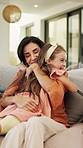 Happy, mother and daughter on sofa with hug, parent care and excited for bonding together on weekend. Woman, child and family embrace in home with wellness, support and love for maternal connection.