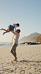Family, father and lift for girl at beach with smile, spin and bonding on vacation in summer. People, children and space with connection, happy or running with games for fun on seaside holiday