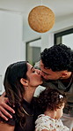 Happy, kiss and parents with kid in home with greeting, bonding and love in family together. Smile, care and girl toddler with mom and dad in kitchen for connection, safety or support in house.
