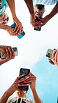 People, hands and circle with phone for network, data sync or sharing app below blue sky in nature. Low angle, community or group of friends with mobile smartphone for connection, unity or support
