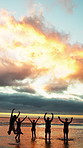 Friends, jump and freedom at beach for holiday, travel or fun together in nature on weekend getaway. Outdoor, sunset and space on summer vacation, shadow and bonding with people on sea adventure