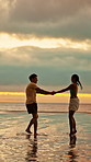 Sunset, dance and love with couple at beach for bonding, romance and connection. Summer vacation, honeymoon getaway and holding hands with man and woman outdoor for date, playful and support