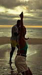 Sparklers, fun and group of friends by beach for summer vacation, getaway or weekend trip together. Fireworks, travel and people by ocean for adventure on seaside holiday with social gathering.
